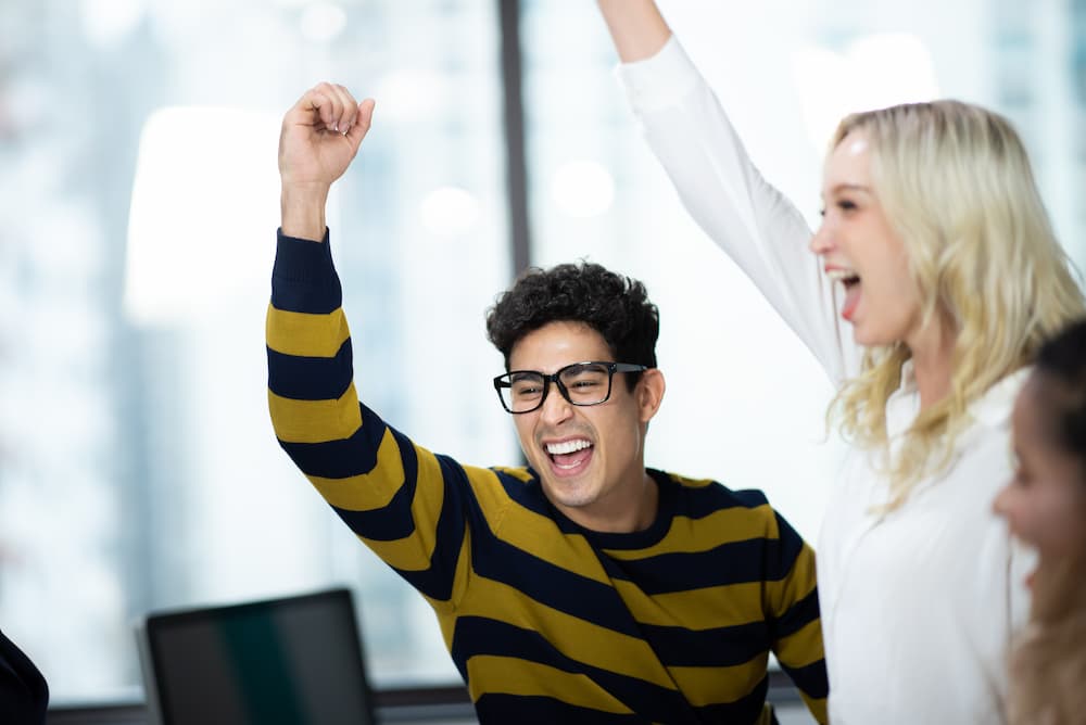 A sales intern celebrating with his member.
